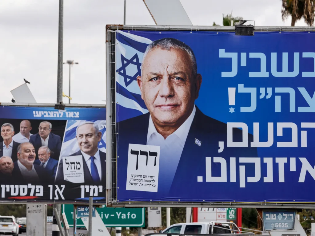 Political campaign billboards featuring Israeli leaders including Gadi Eisenkot and Benjamin Netanyahu along a highway, illustrating political maneuvering in Israeli Coalition Talks.