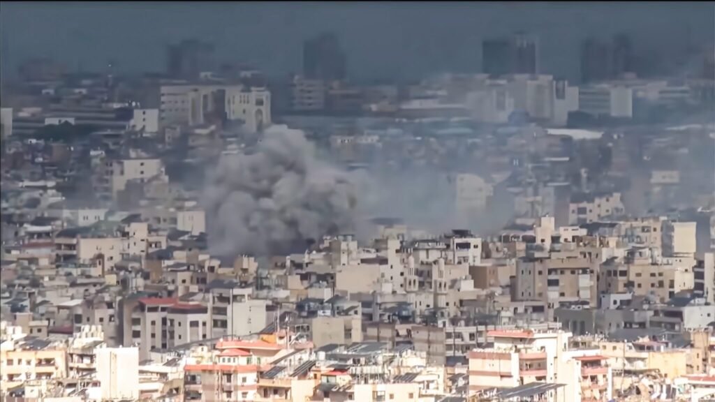 لماذا ستستمر احتلال لبنان بعد المحادثات التي تقودها الولايات المتحدة Plumes of thick grey smoke rising above dense residential buildings in Dahyeh following airstrikes, illustrating security realities behind the Israeli Occupation of Lebanon.