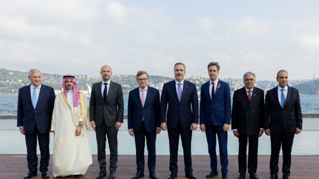Turkish Foreign Minister Hakan Fidan, British Foreign Minister Ed Miliband, and other European and regional counterparts posing together during international negotiations on Iran Diplomacy.