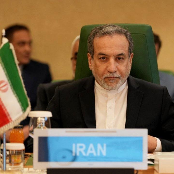 Iran Leadership Vacuum Gives the U.S. Blockade Time to Bite Iranian Foreign Minister Abbas Araghchi seated behind an official Iran delegation nameplate at a summit, reflecting diplomatic pressure amid an Iran Leadership Vacuum.