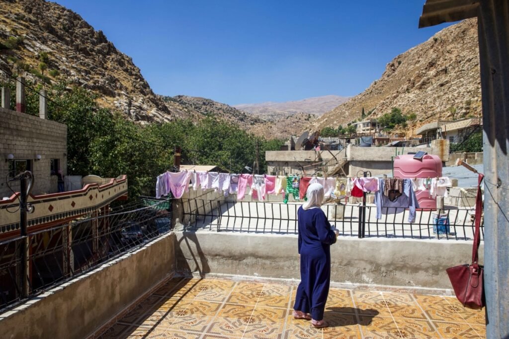 Activist Safa Alsafadi stands on a rooftop in Beit Jinn, Southern Syria, looking at Mount Hermon near Israel's buffer zone.
