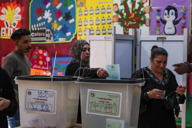 Middle East Liberalism Grows Because Islamist Rule Failed Women casting ballots into transparent boxes at an Egyptian polling station, symbolizing the rise of Middle East Liberalism after Islamist rule failed.