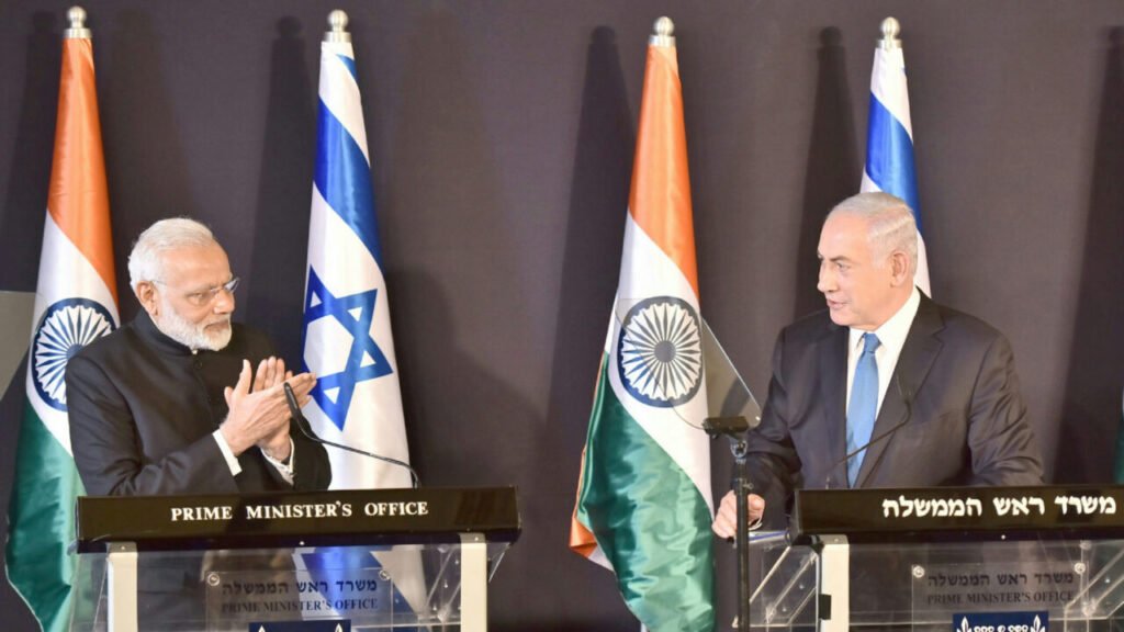 Indian Prime Minister Narendra Modi and Israeli Prime Minister Benjamin Netanyahu at joint press podiums flanked by national flags, illustrating the strategic dynamics of India-Israel Relations.